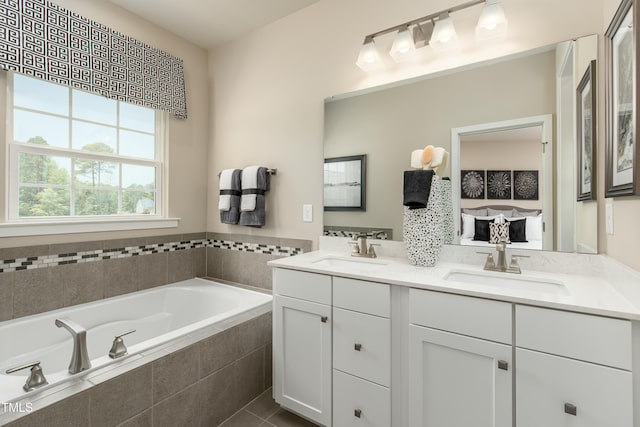 bathroom with a garden tub, connected bathroom, double vanity, and a sink