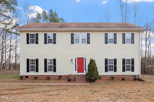 colonial-style house with crawl space, a front lawn, and entry steps