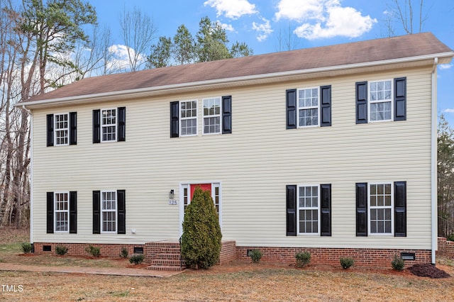 colonial house with crawl space and a shingled roof