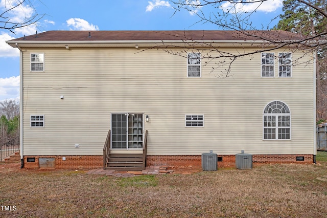 rear view of house with crawl space, a lawn, entry steps, and central AC