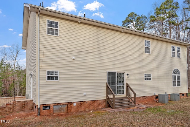 rear view of property with crawl space, cooling unit, and entry steps