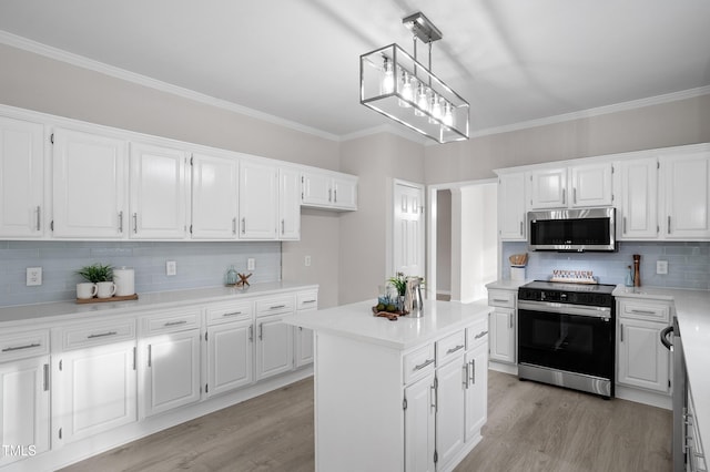 kitchen featuring stainless steel microwave, white cabinets, light wood-type flooring, and electric range oven