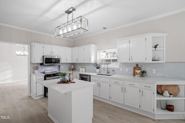 kitchen with open shelves, light wood-style floors, white cabinets, stainless steel appliances, and a sink