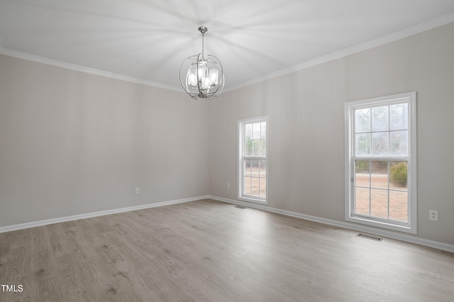 spare room featuring visible vents, light wood-type flooring, crown molding, and an inviting chandelier