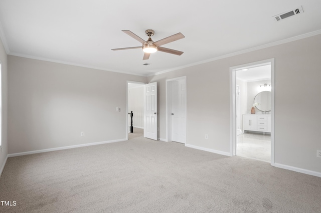 unfurnished bedroom featuring visible vents, light colored carpet, crown molding, and baseboards