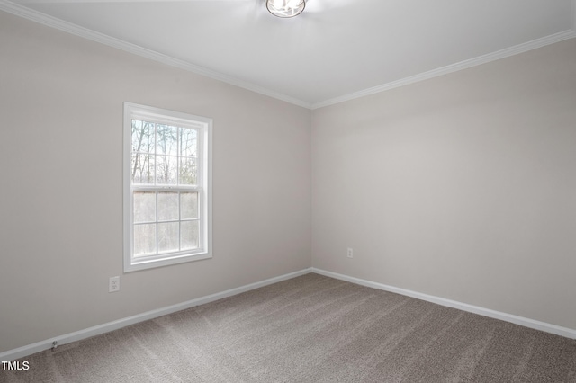 carpeted empty room featuring baseboards and crown molding