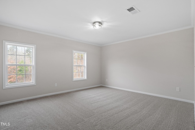 spare room featuring carpet flooring, baseboards, and ornamental molding