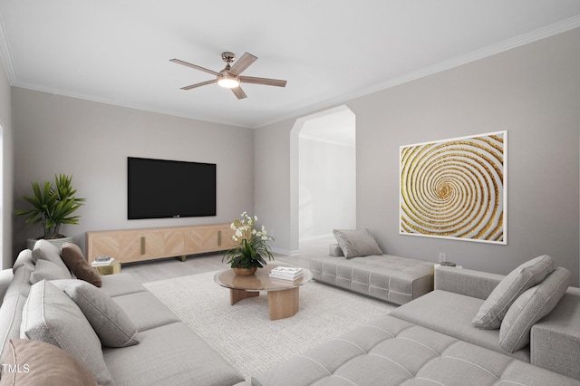 living area featuring arched walkways, crown molding, a ceiling fan, and wood finished floors