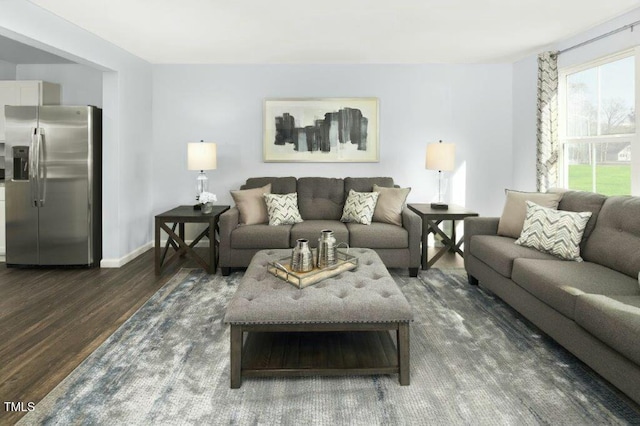 living area featuring dark wood-style floors and baseboards