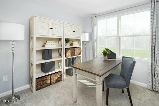 dining room with baseboards, light carpet, and a healthy amount of sunlight