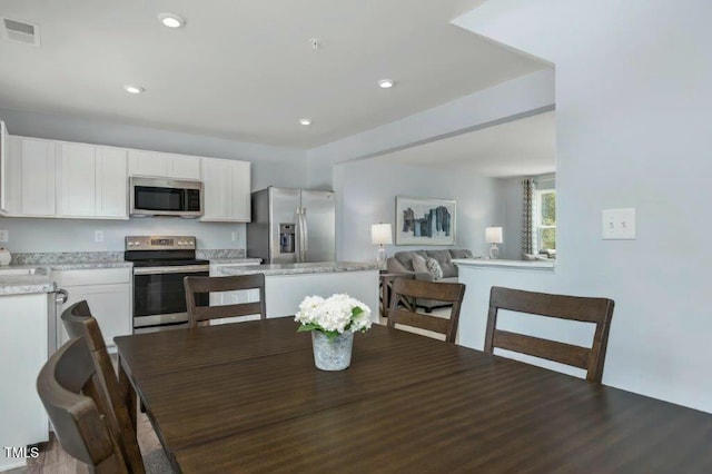 dining area with recessed lighting, visible vents, and dark wood-type flooring