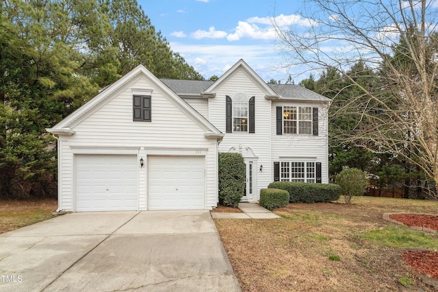 traditional home featuring a front lawn, driveway, and a shingled roof