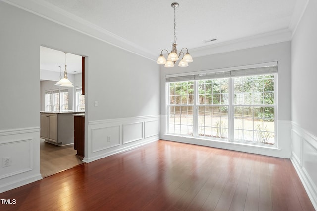 unfurnished dining area featuring a wealth of natural light, visible vents, and dark wood finished floors