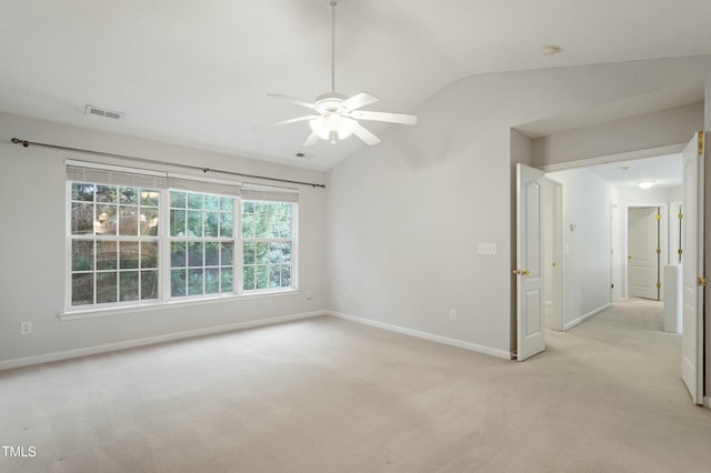 empty room with visible vents, baseboards, lofted ceiling, ceiling fan, and light colored carpet