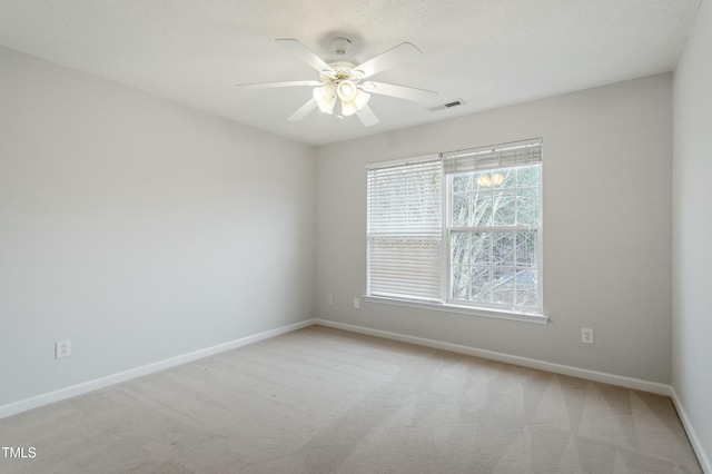 spare room featuring visible vents, baseboards, carpet, and ceiling fan