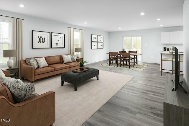 living room with recessed lighting, light wood-style floors, and baseboards