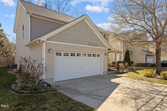 view of side of property featuring concrete driveway and a garage