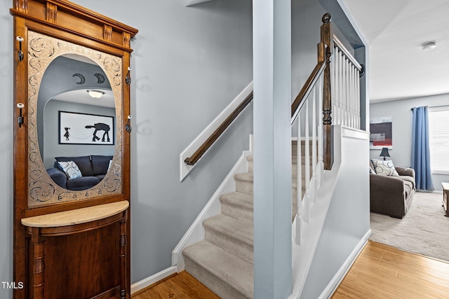 stairs with baseboards and wood finished floors