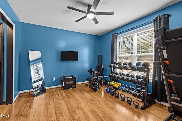 workout room featuring a ceiling fan, wood finished floors, and baseboards