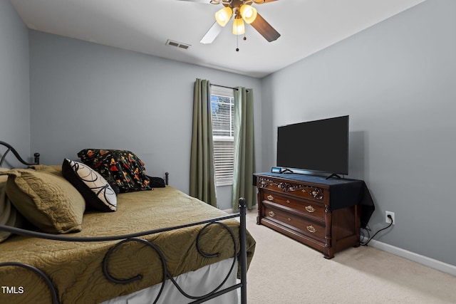 carpeted bedroom with baseboards, visible vents, and ceiling fan