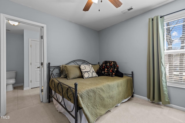 bedroom with visible vents, multiple windows, light colored carpet, and a ceiling fan