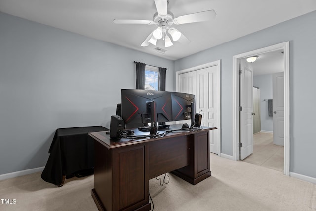 office featuring baseboards, light colored carpet, visible vents, and ceiling fan