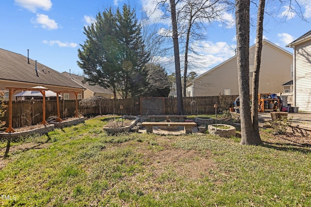 view of yard with fence and a garden