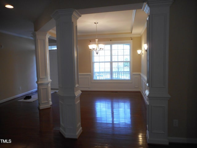 dining room with crown molding, dark wood-type flooring, and decorative columns