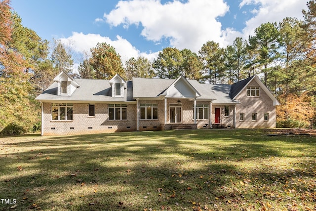 view of front of home with crawl space, brick siding, roof with shingles, and a front yard