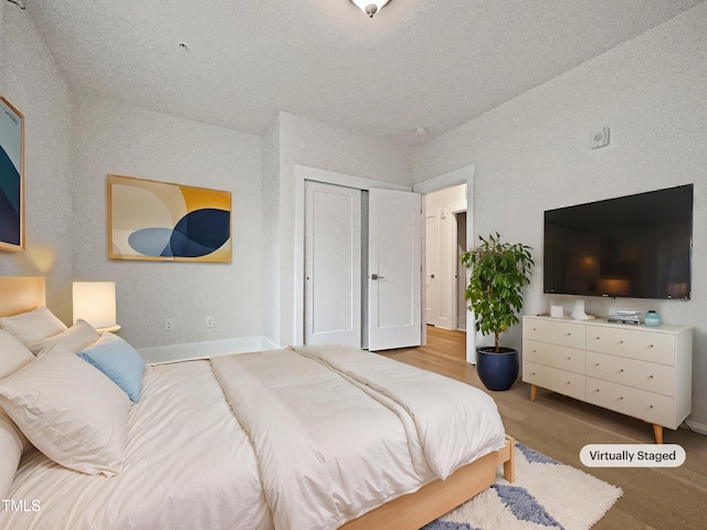 bedroom with a closet and baseboards