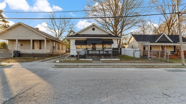 view of front of property with a fenced front yard and a porch