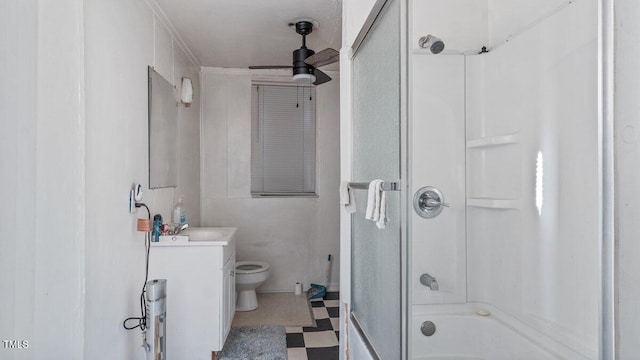 full bathroom featuring toilet, tile patterned floors, combined bath / shower with glass door, vanity, and a ceiling fan