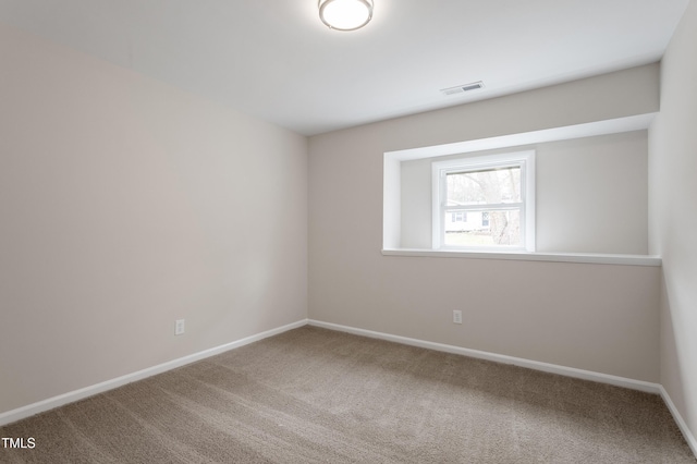 unfurnished room with visible vents, baseboards, and carpet