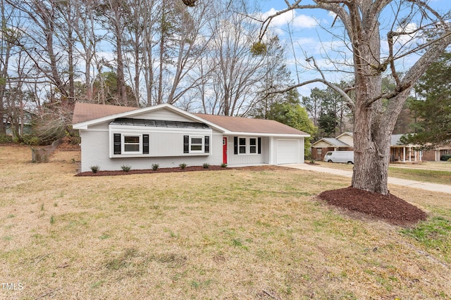 ranch-style home featuring concrete driveway and a front lawn