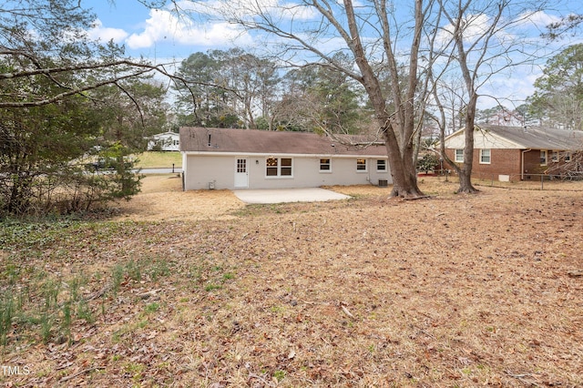 rear view of house with fence and a patio area