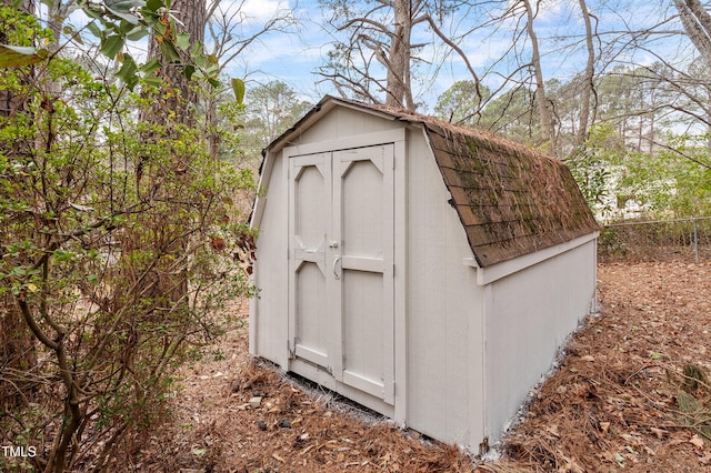 view of shed with fence