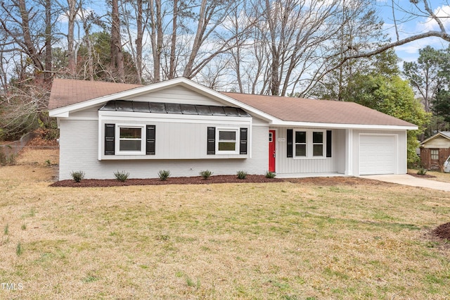 ranch-style home featuring brick siding, a front yard, and an attached garage