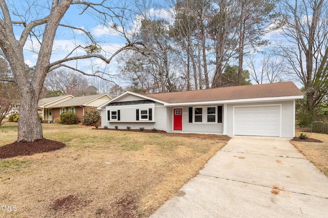 ranch-style house with a shingled roof, concrete driveway, a garage, and a front lawn