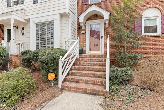 property entrance featuring brick siding