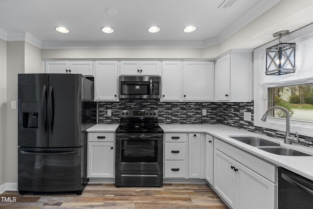 kitchen with black appliances, a sink, white cabinetry, crown molding, and light countertops