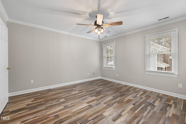 unfurnished room with visible vents, wood finished floors, and ornamental molding