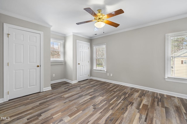 unfurnished bedroom featuring baseboards, wood finished floors, a ceiling fan, and ornamental molding