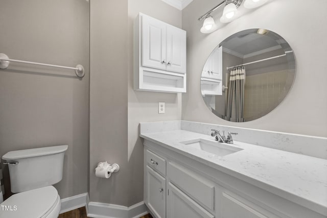 bathroom with crown molding, baseboards, toilet, a shower with curtain, and vanity