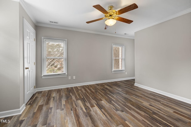 spare room with visible vents, ceiling fan, baseboards, ornamental molding, and dark wood-style floors