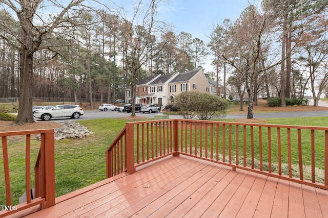 wooden terrace with a residential view and a lawn