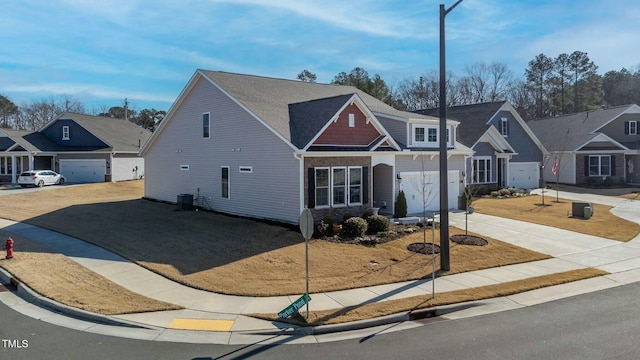 view of front of home with a garage, a residential view, and driveway