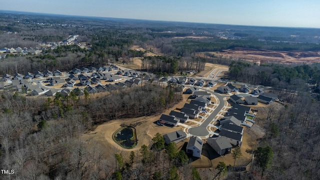 birds eye view of property with a forest view and a residential view