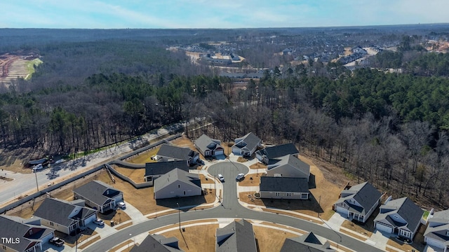 drone / aerial view with a view of trees and a residential view