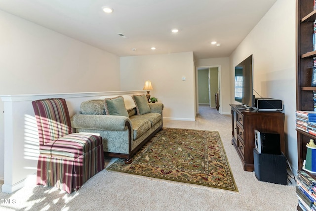 living area with recessed lighting, visible vents, baseboards, and light colored carpet