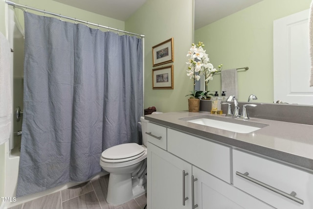 bathroom featuring vanity, toilet, and shower / bath combo with shower curtain